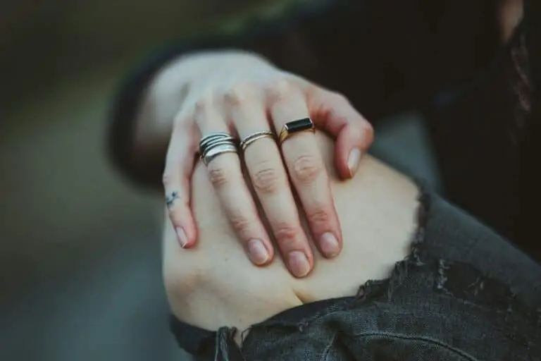 photo of person showing silver-colored ring